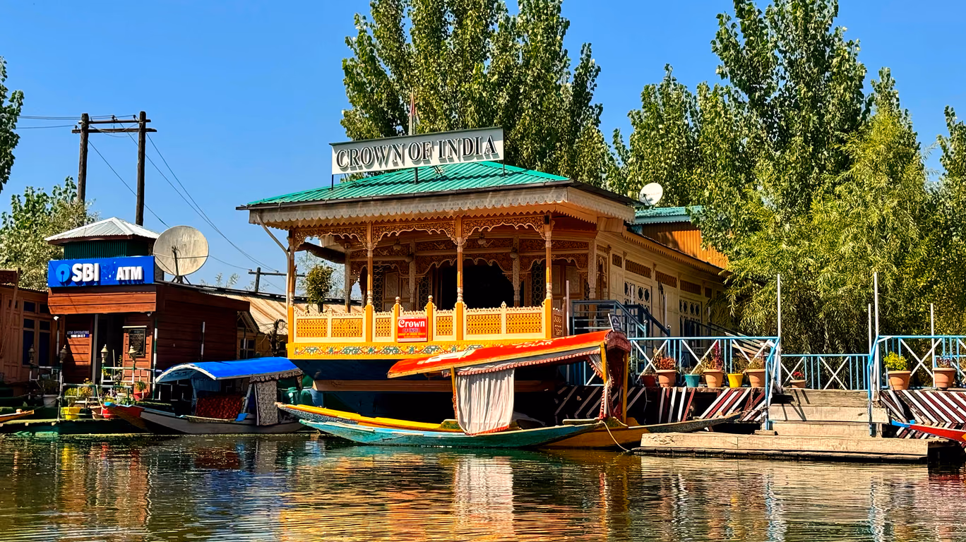 Crown of India houseboat on Dal Lake with shikaras moored at its front deck
